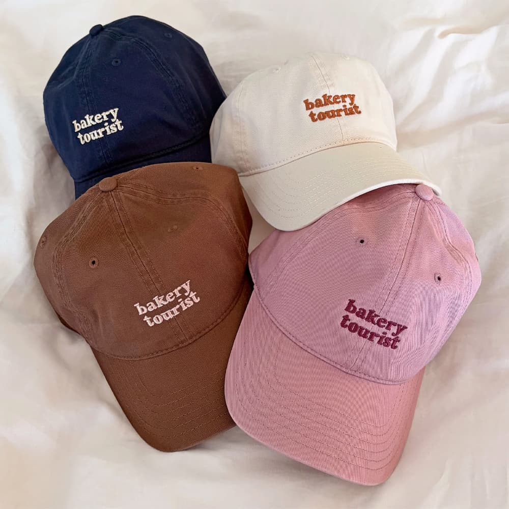 Caps, totes, and soft merch from YM Studio
